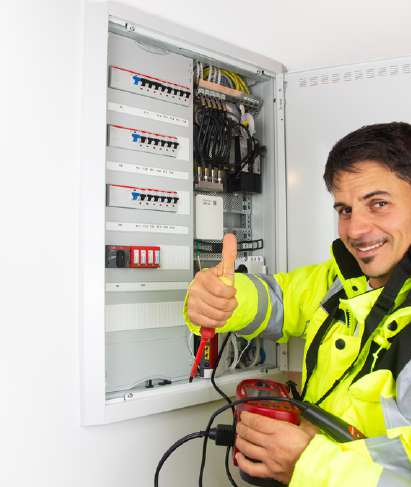 Electrician commissioning an inverter and distribution board