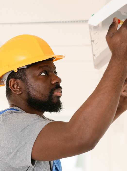Ayoba technician installing electrical equipment